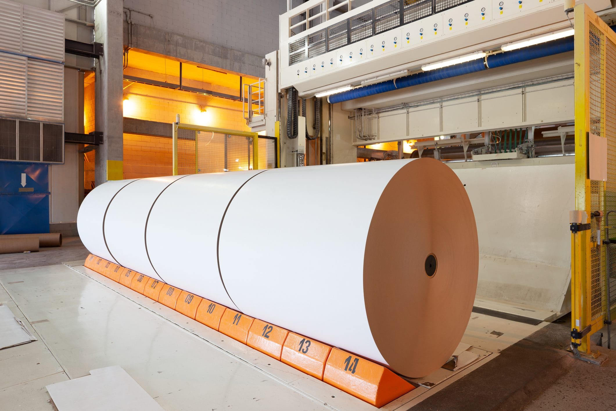 Large industrial paper rolls in a factory.