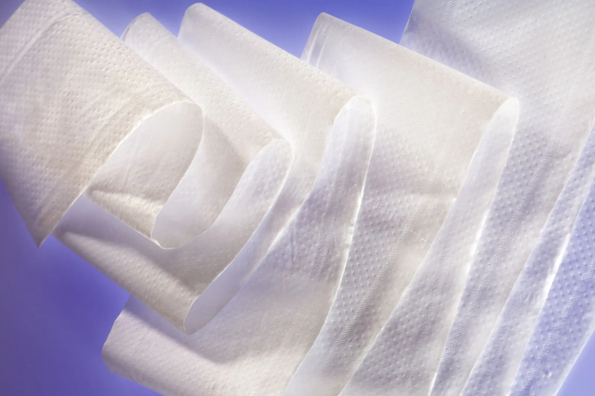 White paper towels on a purple background.