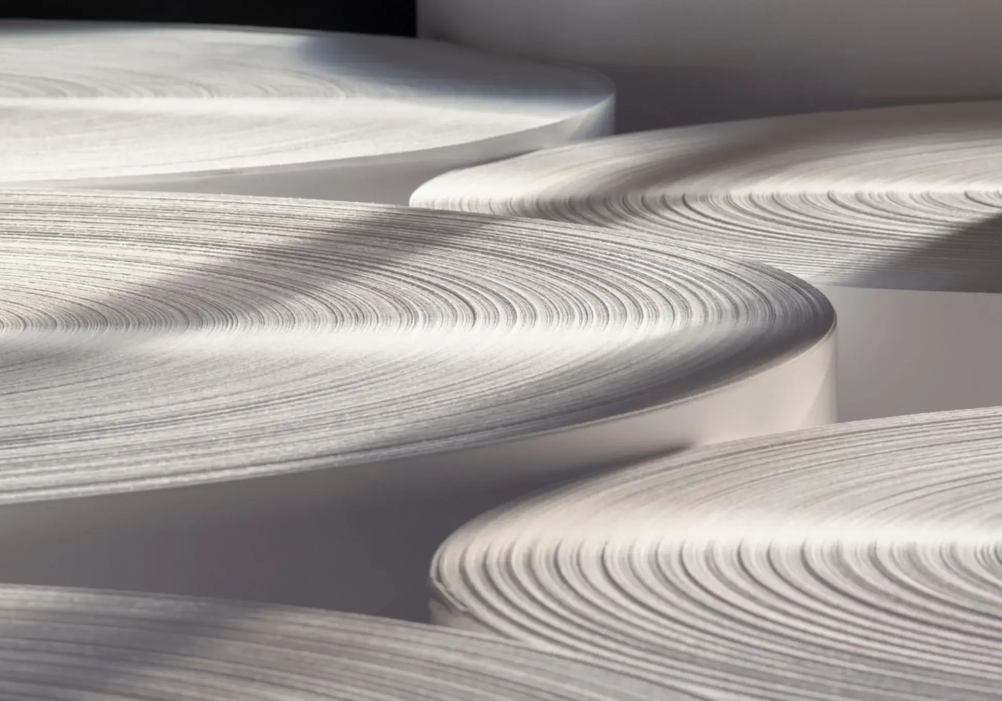 Large rolls of white paper stacked together.